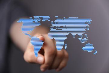 Hand pointing at a digital world map, illustrating global connectivity and networking.