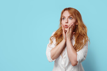 Close-up portrait of nice, redhead attractive girl opened mouth. The woman is surprised.