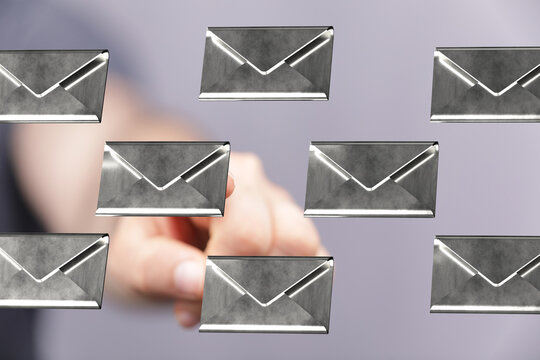 Person interacting with digital email envelopes.  Concept for email management, inbox overload.
