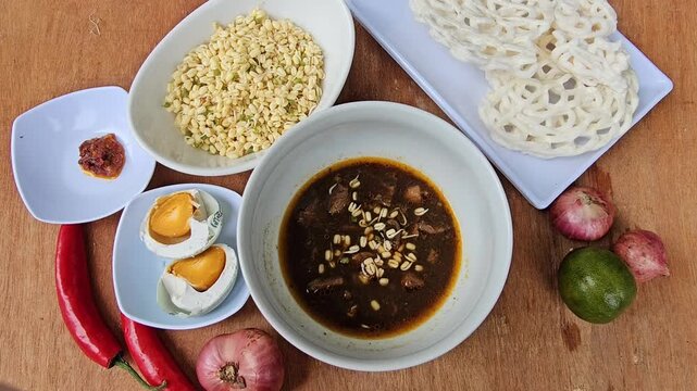 cup of coffee,Rawon is Indonesian traditional beef black soup,Original dish from East Java,served with steamed rice,boiled salted duck egg,chili sauce or sambal,bean sprouts and onion crackers