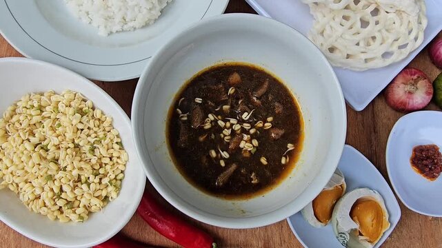 cup of coffee,Rawon is Indonesian traditional beef black soup,Original dish from East Java,served with steamed rice,boiled salted duck egg,chili sauce or sambal,bean sprouts and onion crackers