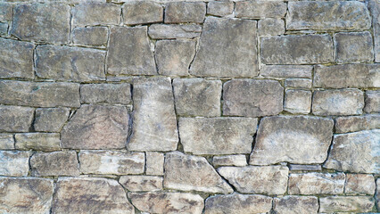 Close-up view of an ancient stone wall showcasing various rock textures and shapes in a historic setting
