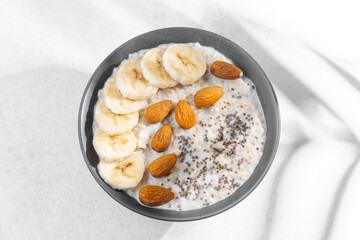 Banana almond chia seed oatmeal bowl in bright light