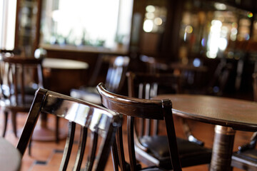 Stock photo of empty chairs and tables in a cafe or restaurant setting. Perfect for articles about the hospitality industry or quiet moments.