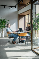 Two It Software engineers working on project and programming in coffee shop. Business people concept
