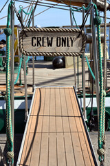 Crew Only sign placed at the entrance to a ship or yacht. A concept for businesses, corporations or offices.