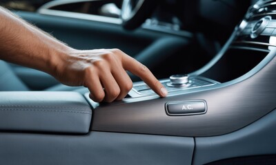 Naklejka premium Finger presses AC button on luxury car console, sleek design