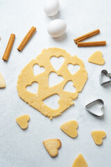 Heart cookie dough baking with cinnamon on marble surface for recipe, valentine or lifestyle concept