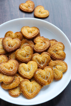Golden, heart shaped crispy biscuits with a light, flaky texture, coated with sparkling sugar crystals. Ideal for snack concepts, food photography, or sweet treat presentations. Little hearts.