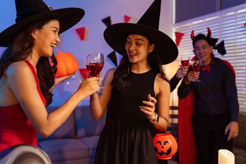Dinner and group of people celebrating together at Halloween party.