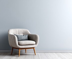 A light gray armchair with a dark gray cushion sits against a pale gray wall in a simple, serene room.