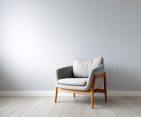A light gray upholstered armchair sits against a pale gray wall, casting a serene and minimalist mood in a modern living area.