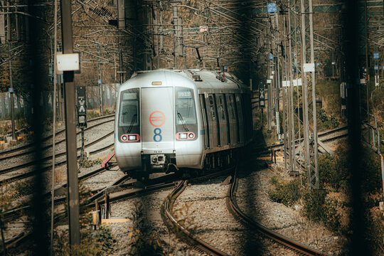 Pictures of Delhi Metro train. Metro rail in Delhi. View of The Delhi Metro is running on the tracks towards the Blue Line and Pink Line.