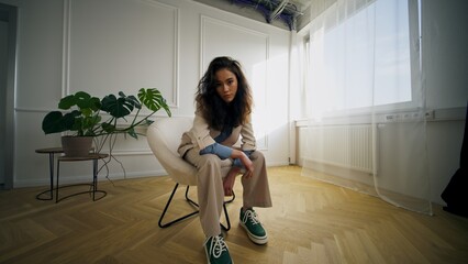 This is a contemplative portrait captured in a modern interior setting with style