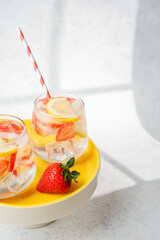 Strawberry lemonade in glasses with red straws