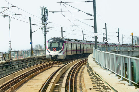 Pictures of Delhi Metro train. Metro rail in Delhi. View of The Delhi Metro is running on the tracks towards the Blue Line and Pink Line.