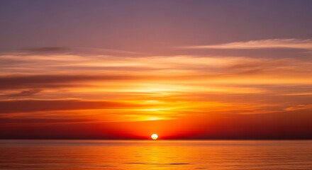 Fototapeta premium Vibrant hues of the setting sun reflected on the tranquil ocean surface creating a serene and beautiful landscape