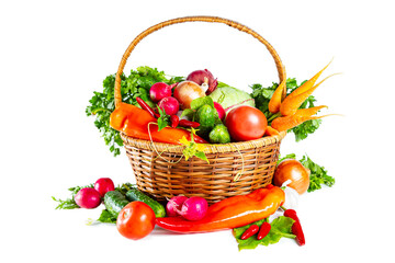 Fresh shiny different vegetables in a wicker basket. Isolated on white background.