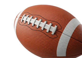 Close up of a textured american football ball with white laces ready for game play on a dark surface
