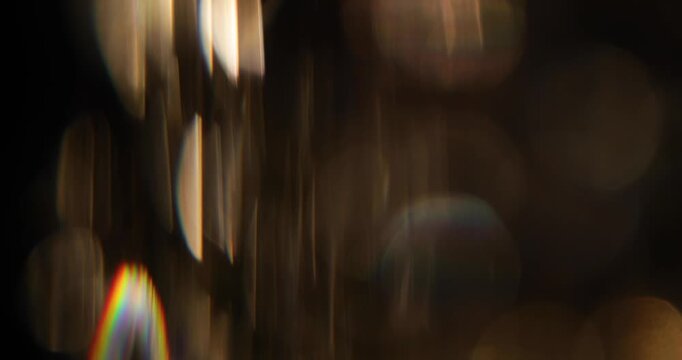 Abstract blurred light leaks on black background with copy space. Studio anamorphic lens flare bokeh effect.
