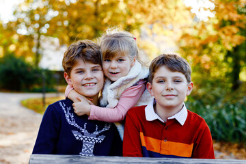 Portrait of three siblings children. Two kids brothers boys and little cute toddler sister girl...