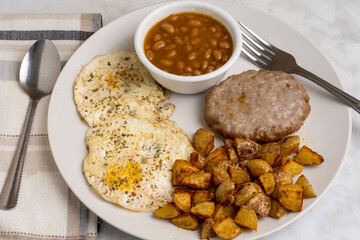 eggs over easy  with sausage patty and baked beans
