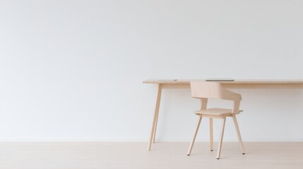 organized. A clean and simple office corner featuring a wooden desk and chair under soft natural light. real-estate listings.