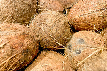 Coconuts in basket at grocery store, fruits and vegetables are sold at market