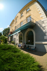 Outdoor cafe seating next to classic urban building