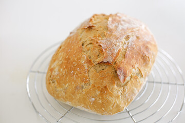 Freshly baked homemade bread cooling on rack