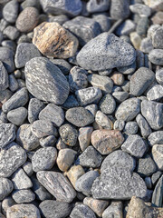 The grey pebbles background at the Norwegian sea coast