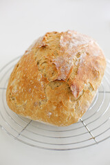 Rustic homemade bread cooling on wire rack