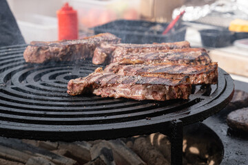 Grilled steaks at street food festival with chef in background