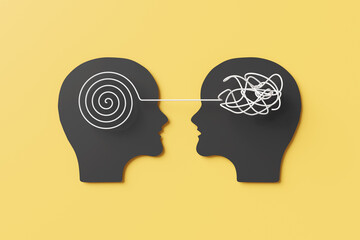 Black paper cutout of 2 face to face human heads having a neatly spiral pattern in one brain connecting to a messy thread of another person. Illustration of point of view, belief and communication