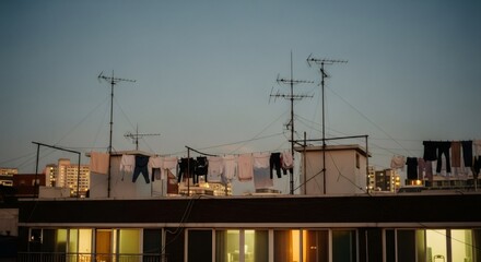 Retro urban rooftop scene with clotheslines and antennas at dusk. Nostalgic 80s-90s cityscape view capturing melancholic vibe. VHS-style photograph for vintage mood board