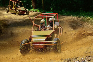 Tourists are enjoying a thrilling buggy adventure on a muddy road in punta cana, dominican republic