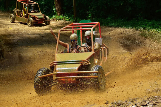Tourists are enjoying a thrilling buggy adventure on a muddy road in punta cana, dominican republic