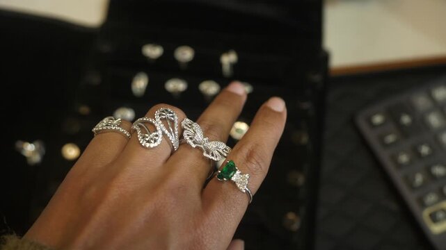 Designer and trendy silver finger rings on hand studded with lab grown diamonds, Closeup