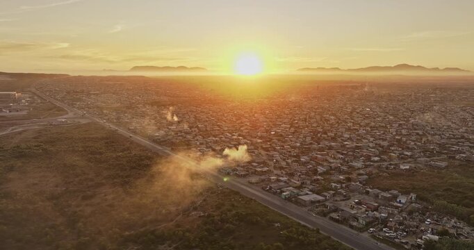 Cape Town South Africa Aerial v112 flyover Macassar capturing views of Baden Powell Dr, Khayelitsha township slums and mountains on the skyline at sunset - Shot with Mavic 3 Pro Cine - Jan 11th 2024