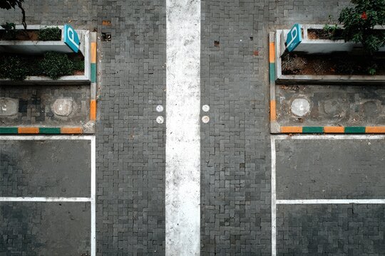 High-angle view of parking spaces separated by a white line