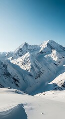 Fototapeta premium Snowy mountain peaks rise majestically against a vibrant blue sky, showcasing a pristine winter landscape.