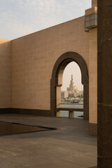 Iconic Spiral Minaret Through Stone Archway in Doha