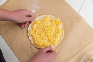 cheese tortilla made of dough and grated cheese, thinly rolled yeast dough sprinkled with yellow hard grated cheese