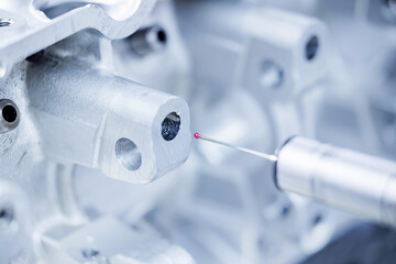 Cnc coordinate measuring machine inspecting metallic component in precision engineering