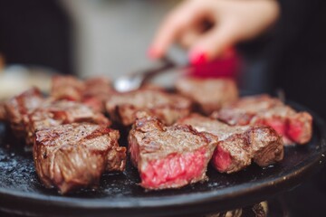 Sizzling steaks dance on a hot grill, evoking Argentinian asado vibes, perfect for National BBQ Month or Carnivore's Day