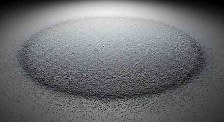 Heap of small black granules on a gradient gray surface studio shot
