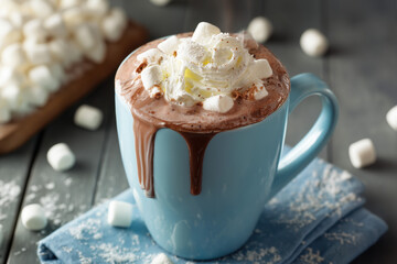 hot cocoa with whipped cream and marshmallows in a mug, festive christmas setting