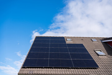 Black solar panels on modern house roof