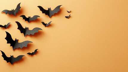 halloween and decoration concept with paper bats flying on orange background, free space for text