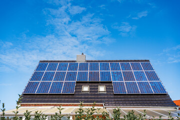 Blue photovoltaic panels on residential roof